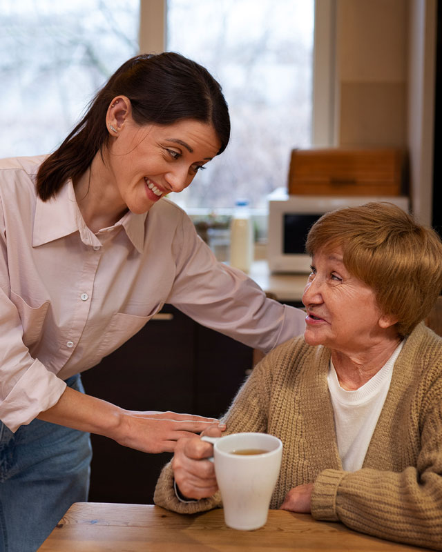 freepik-female-caretaker-with-client-home-doing-her-job-2